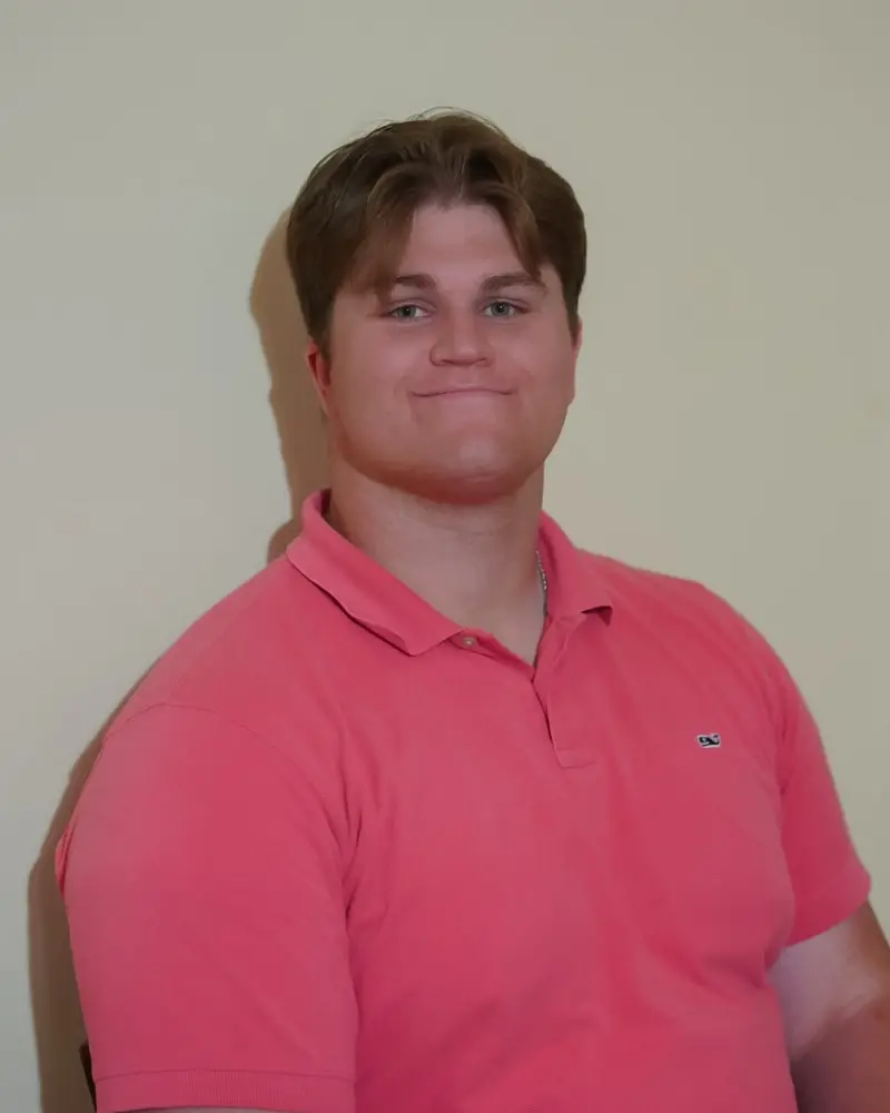Luke Haws, web designer in Eden, Utah, smiling in a coral polo shirt