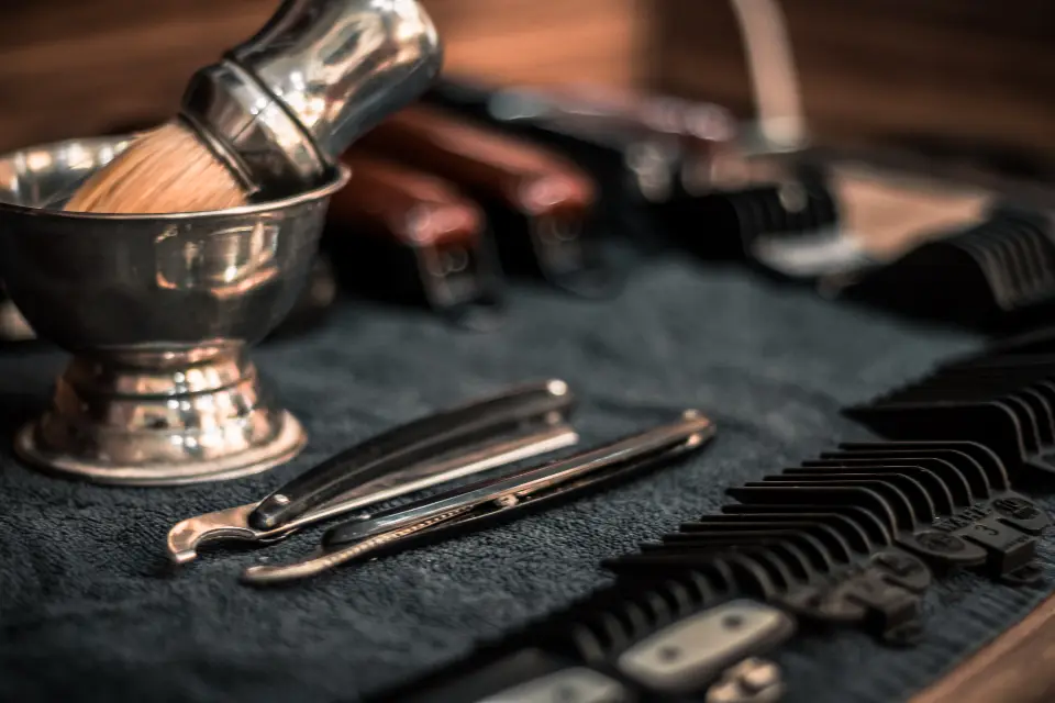 Shaving brush, bowl, and razors laid out on a barber’s station